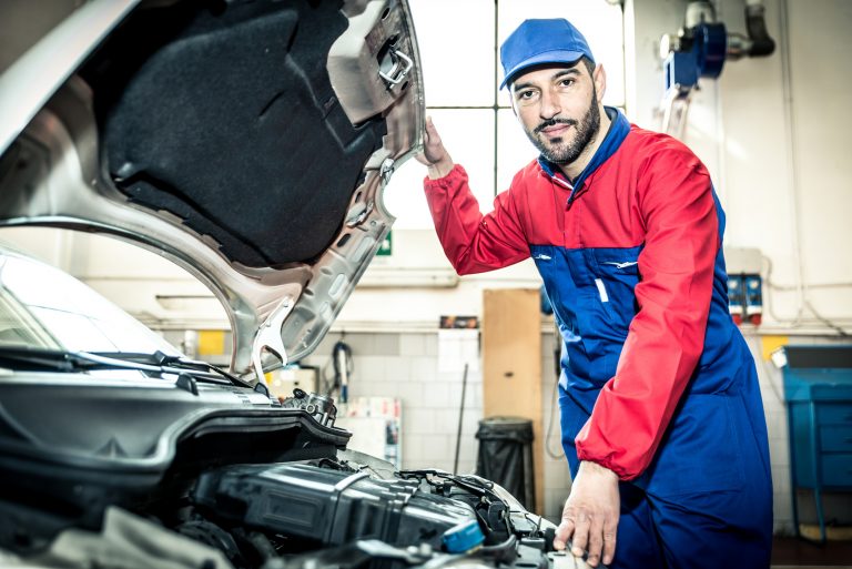 Mechanic portrait while working on a car. industrial concept about transportation